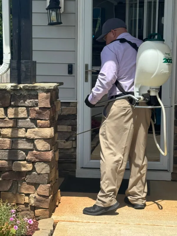 Joe Thigpen treating a Clayton, NC home for Priority One Pest Solutions